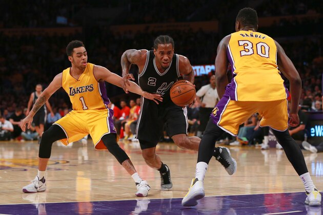 LOS ANGELES, CA - JANUARY 22: Kawhi Leonard #2 of the San Antonio Spurs dribbles to the basket against D'Angelo Russell #1 and Julius Randle #30 of the Los Angeles Lakers in the second half during the NBA game at Staples Center on January 22, 2016 in Los Angeles, California. The Spurs defeated the Lakers 108 - 95. NOTE TO USER: User expressly acknowledges and agrees that, by downloading and or using this photograph, User is consenting to the terms and conditions of the Getty Images License Agreement. (Photo by Victor Decolongon/Getty Images) LOS ANGELES, CA - JANUARY 22: Kawhi Leonard #2 of the San Antonio Spurs dribbles to the basket against D'Angelo Russell #1 and Julius Randle #30 of the Los Angeles Lakers in the second half during the NBA game at Staples Center on January 22, 2016 in Los Angeles, California. The Spurs defeated the Lakers 108 - 95. NOTE TO USER: User expressly acknowledges and agrees that, by downloading and or using this photograph, User is consenting to the terms and conditions of the Getty Images License Agreement. (Photo by Victor Decolongon/Getty Images)