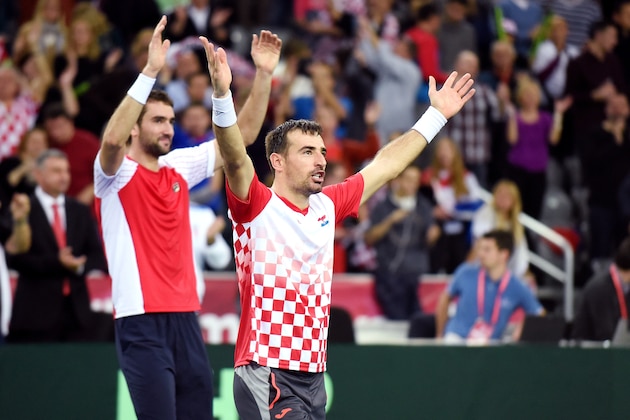 Croatia's tennis players Ivan Dodig (C) and Marin Cilic (rear L) celebrate after winning the Davis Cup World Group final doubles match between Croatia and Argentina at the Arena hall in Zagreb, on November 26, 2016. / AFP / STRINGER        (Photo credit should read STRINGER/AFP/Getty Images)