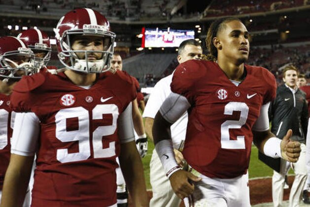 Alabama quarterback Jalen Hurts, right, runs off the field after the game against Chattanooga during the second half of an NCAA college football game, Saturday, Nov. 19, 2016, in Tuscaloosa, Ala. (AP Photo/Brynn Anderson)