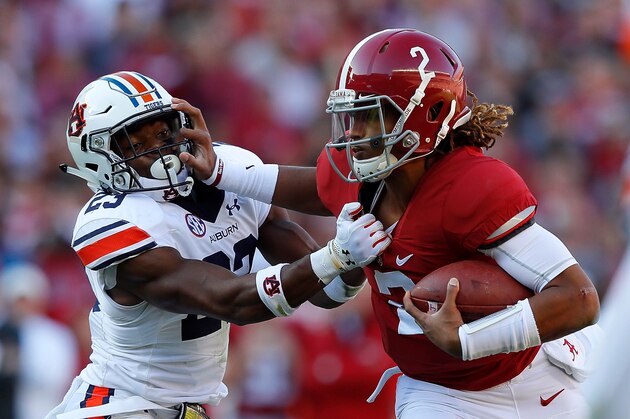 TUSCALOOSA, AL - NOVEMBER 26:  Jalen Hurts #2 of the Alabama Crimson Tide tries to break a tackle by Johnathan Ford #23 of the Auburn Tigers  at Bryant-Denny Stadium on November 26, 2016 in Tuscaloosa, Alabama.  (Photo by Kevin C. Cox/Getty Images)