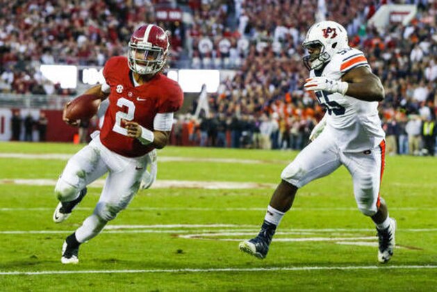 Alabama quarterback Jalen Hurts (2) scrambles past Auburn defensive lineman Carl Lawson (55) and runs in for a touchdown during the first half of the Iron Bowl NCAA college football game, Saturday, Nov. 26, 2016, in Tuscaloosa, Ala. (AP Photo/Butch Dill)