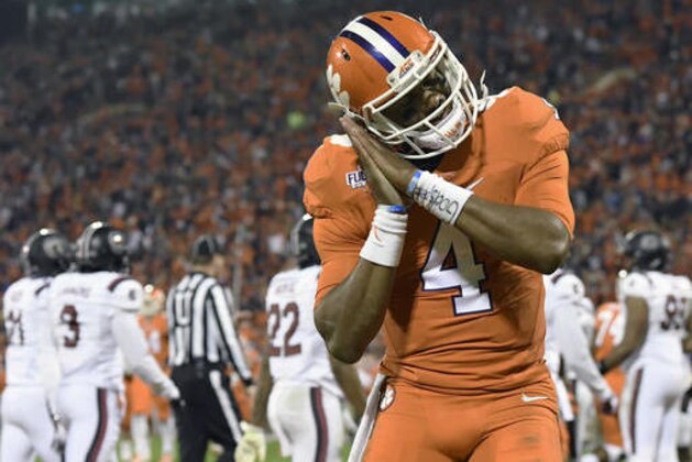 Clemson quarterback Deshaun Watson reacts after throwing a touchdown pass to Artavis Scott during the second half of an NCAA college football game against South Carolina Saturday, Nov. 26, 2016, in Clemson, S.C. (AP Photo/Richard Shiro)