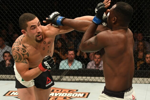 MELBOURNE, AUSTRALIA - NOVEMBER 27:   (L-R) Robert Whittaker of New Zealand punches Derek Brunson in their middleweight bout during the UFC Fight Night event at Rod Laver Arena on November 27, 2016 in Melbourne, Australia. (Photo by Jeff Bottari/Zuffa LLC/Zuffa LLC via Getty Images)
