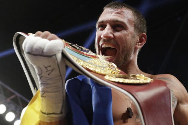 Vasyl Lomachenko, of Ukraine, celebrates after defeating Nicholas Walters, of Jamaica, in a WBO junior lightweight title boxing match Saturday, Nov. 26, 2016, in Las Vegas. (AP Photo/John Locher)