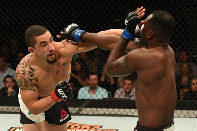 MELBOURNE, AUSTRALIA - NOVEMBER 27:   (L-R) Robert Whittaker of New Zealand punches Derek Brunson in their middleweight bout during the UFC Fight Night event at Rod Laver Arena on November 27, 2016 in Melbourne, Australia. (Photo by Jeff Bottari/Zuffa LLC/Zuffa LLC via Getty Images)