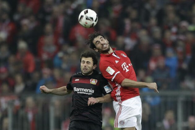 Leverkusen's Admir Mehmedi, left, and Bayern's Javi Martinez challenge for the ball during the German Bundesliga soccer match between FC Bayern Munich and Bayer Leverkusen 04 at the Allianz Arena stadium in Munich, Germany, Saturday, Nov. 26, 2016. (AP Photo/Matthias Schrader)