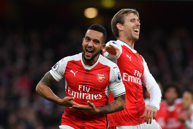 Arsenal's English midfielder Theo Walcott (L) celebrates with Arsenal's Spanish defender Nacho Monreal after scoring their second goal during the English Premier League football match between Arsenal and Bournemouth at the Emirates Stadium in London on November 27, 2016.  / AFP / Ben STANSALL / RESTRICTED TO EDITORIAL USE. No use with unauthorized audio, video, data, fixture lists, club/league logos or 'live' services. Online in-match use limited to 75 images, no video emulation. No use in betting, games or single club/league/player publications.  /         (Photo credit should read BEN STANSALL/AFP/Getty Images)