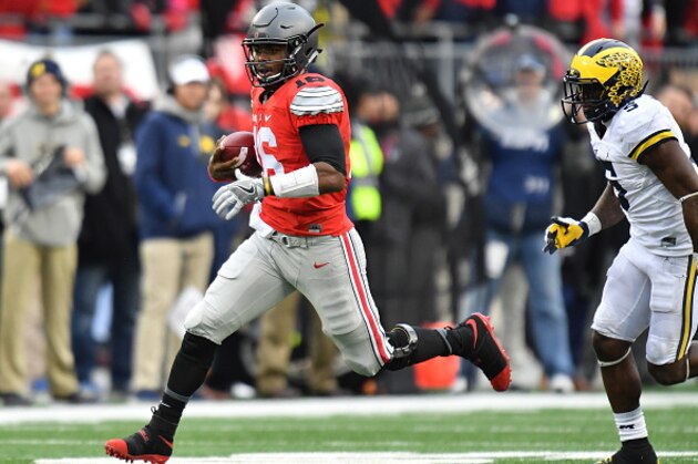 COLUMBUS, OH - NOVEMBER 26:   J.T. Barrett #16 of the Ohio State Buckeyes rushes the ball during overtime against the Michigan Wolverines at Ohio Stadium on November 26, 2016 in Columbus, Ohio.  (Photo by Jamie Sabau/Getty Images)