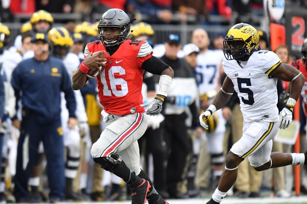 COLUMBUS, OH - NOVEMBER 26:   J.T. Barrett #16 of the Ohio State Buckeyes rushes the ball during overtime against the Michigan Wolverines at Ohio Stadium on November 26, 2016 in Columbus, Ohio.  (Photo by Jamie Sabau/Getty Images)