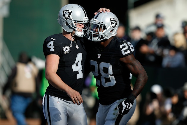 OAKLAND, CA - NOVEMBER 27:  Latavius Murray #28 and Derek Carr #4 of the Oakland Raiders celebrate after a touchdown against the Carolina Panthers during their NFL game on November 27, 2016 in Oakland, California.  (Photo by Lachlan Cunningham/Getty Images)