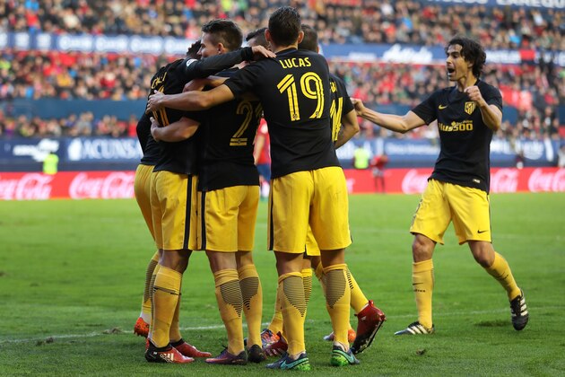 Atletico Madrid's French forward Kevin Gameiro (2L) celebrates with teammates during the Spanish league football match CA Osasuna vs Club Atletico de Madrid at El Sadar stadium in Pamplona, on November 27, 2016. / AFP / CESAR MANSO        (Photo credit should read CESAR MANSO/AFP/Getty Images)
