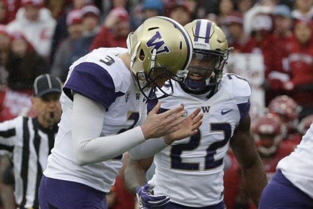 Washington quarterback Jake Browning, left, reacts to a false start penalty on his team as he stands next to running back Lavon Coleman (22) in the first half of an NCAA college football game against Washington State, Friday, Nov. 25, 2016, in Pullman, Wash. (AP Photo/Ted S. Warren)