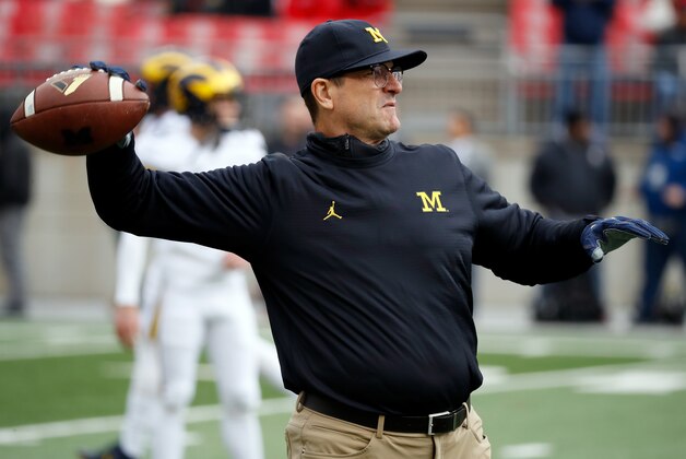 COLUMBUS, OH - NOVEMBER 26:   Head coach Jim Harbaugh of the Michigan Wolverines participates in warmups with is team on the field prior to their game against the Ohio State Buckeyes at Ohio Stadium on November 26, 2016 in Columbus, Ohio.  (Photo by Gregory Shamus/Getty Images)
