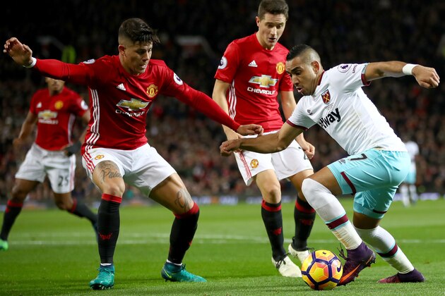 MANCHESTER, ENGLAND - NOVEMBER 27: Dimitri Payet of West Ham United (R) attempts to take the ball past Marcos Rojo of Manchester United (L) during the Premier League match between Manchester United and West Ham United at Old Trafford on November 27, 2016 in Manchester, England.  (Photo by Clive Brunskill/Getty Images)