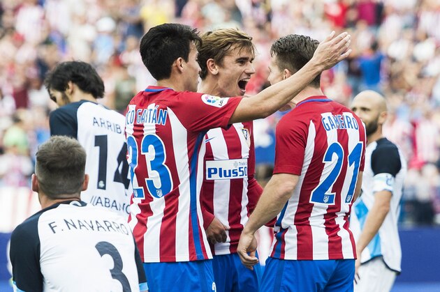 MADRID - SEPTEMBER 25: Antoine Griezmann of Atletico Madrid celebrates with Nicolas Gaitan and Kevin Gameiro during their La Liga match between Atletico Madrid and Deportivo de la Coruna at the Vicente Calderon Stadium on 25 September 2016 in Madrid, Spain. (Photo by Power Sport Images/Getty Images)