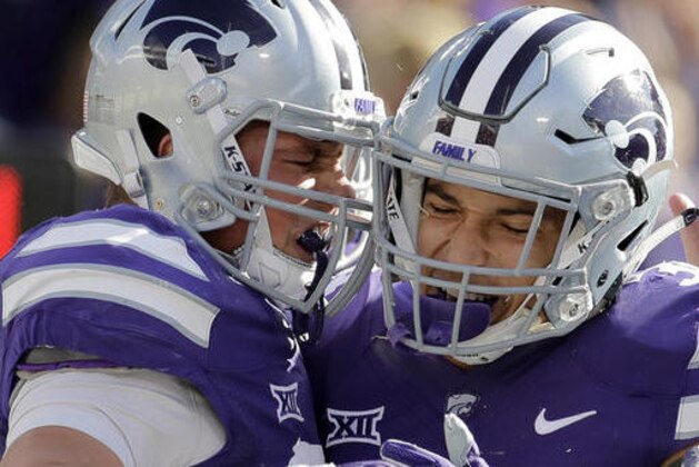 Kansas State fullback Winston Dimel, left, and running back Alex Barnes celebrate after Dimel ran the ball for a touchdown during the first half of an NCAA college football game against Kansas Saturday, Nov. 26, 2016, in Manhattan, Kan. (AP Photo/Charlie Riedel)