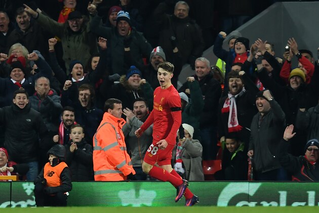 Liverpool's Welsh striker Ben Woodburn (L) celebrates scoring his team's second goal during the English League Cup quarter-final football match between Liverpool and Leeds United at Anfield in Liverpool, north west England on November 29, 2016. / AFP / Paul ELLIS / RESTRICTED TO EDITORIAL USE. No use with unauthorized audio, video, data, fixture lists, club/league logos or 'live' services. Online in-match use limited to 75 images, no video emulation. No use in betting, games or single club/league/player publications.  /         (Photo credit should read PAUL ELLIS/AFP/Getty Images)