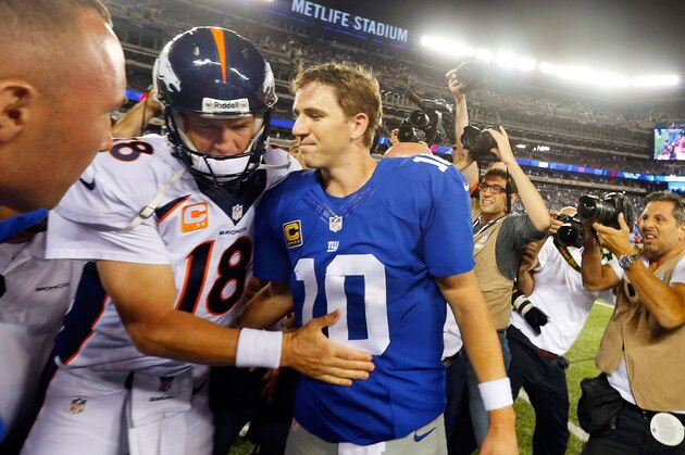 EAST RUTHERFORD, NJ - SEPTEMBER 15:  (NEW YORK DAILIES OUT)   Quarterbacks Peyton Manning #18 of the Denver Broncos and Eli Manning #10 of the New York Giants meet after their game on September 15, 2013 at MetLife Stadium in East Rutherford, New Jersey. The Broncos defeated the Giants 41-23.  (Photo by Jim McIsaac/Getty Images)