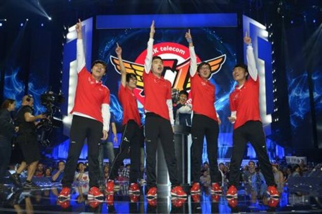 Members of South Korea's SK Telecom T1 team celebrate after defeating China's Royal Club at the League of Legends Season 3 World Championship Final, Friday, Oct. 4, 2013, in Los Angeles. The SK Telecom T1 team won 3-0. (AP Photo/Mark J. Terrill)