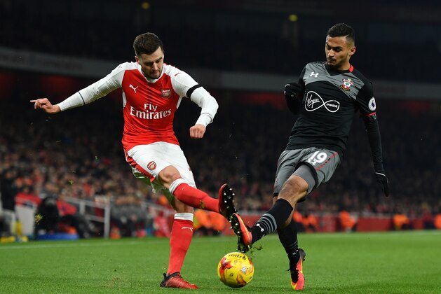 LONDON, ENGLAND - NOVEMBER 30: Carl Jenkinson of Arsenal crosses ahead of Sofiane Boufal of Southampton during the EFL Cup quarter final match between Arsenal and Southampton at the Emirates Stadium on November 30, 2016 in London, England.  (Photo by Mike Hewitt/Getty Images)