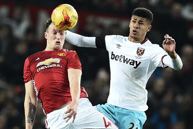 Manchester United's English defender Phil Jones (L) vies in the air with West Ham United's English striker Ashley Fletcher during the EFL (English Football League) Cup quarter-final football match between Manchester United and West Ham United at Old Trafford in Manchester, north west England, on November 30, 2016. / AFP / Oli SCARFF / RESTRICTED TO EDITORIAL USE. No use with unauthorized audio, video, data, fixture lists, club/league logos or 'live' services. Online in-match use limited to 75 images, no video emulation. No use in betting, games or single club/league/player publications.  /         (Photo credit should read OLI SCARFF/AFP/Getty Images)