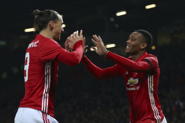 Manchester United's Anthony Martial, right, celebrates with teammate Manchester United's Zlatan Ibrahimovic after scoring his side 2nd goal of the game during the English League Cup quarterfinal soccer match between manchester United and West Ham United at Old Trafford in Manchester, England Wednesday, Nov. 30, 2016. (AP Photo/Dave Thompson)
