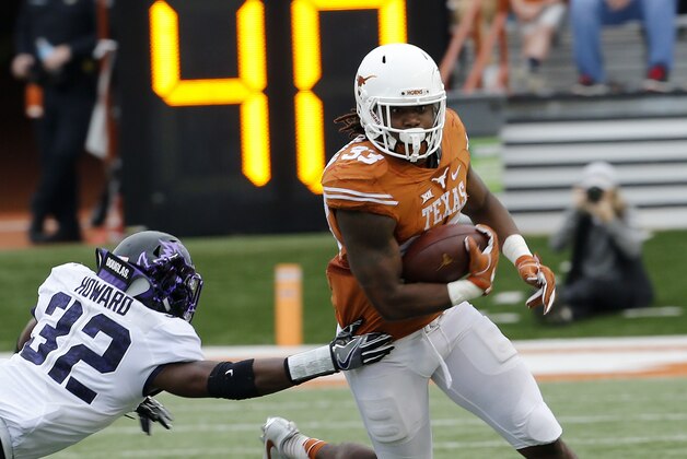 AUSTIN, TX - NOVEMBER 25: D'Onta Foreman #33 of the Texas Longhorns runs past Travin Howard #32 of the TCU Horned Frogs at Darrell K Royal -Texas Memorial Stadium on November 25, 2016 in Austin, Texas. (Photo by Chris Covatta/Getty Images)