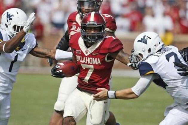 FILE - In this Saturday, Oct, 3, 2015 file photo, West Virginia wide receiver Shelton Gibson (1) and quarterback Skyler Howard (3) move in to tackle Oklahoma's Jordan Thomas (7) after Thomas intercepted a pass intended for Gibson and carried it back 38 yards in the fourth quarter of an NCAA college football game in Norman, Okla. Oklahoma's defense might need to reach midseason form in the opener. Houston, led by explosive quarterback Greg Ward, Jr., is ranked 15th and looking to make a jump on the big stage against the third-ranked Sooners on Saturday at Reliant Stadium. (AP Photo/Sue Ogrocki, File)