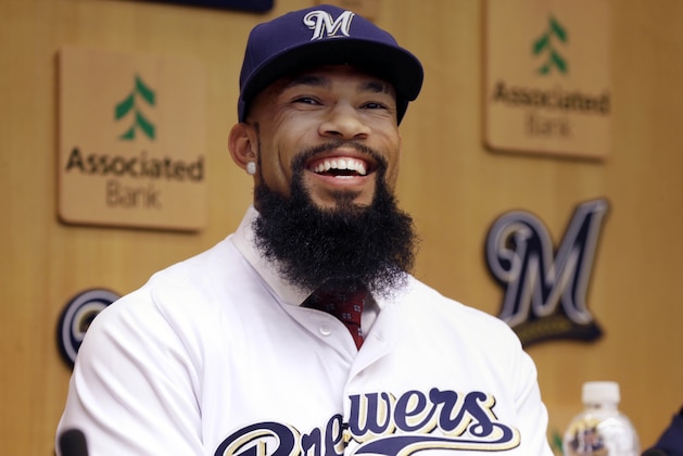 FILE - In this March 12, 2013, file photo, Seattle Mariners' Eric Thames hits against the Arizona Diamondbacks during the fourth inning in an exhibition spring training baseball game in Peoria, Ariz. The Milwaukee Brewers have signed free agent Eric Thames, Tuesday, Nov. 29, 2016, who spent the last three seasons in Korea, and designated slugging first baseman Chris Carter for assignment. (AP Photo/Gregory Bull, File)