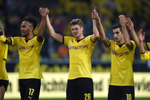 Dortmund´s players including (from L) Gabonese striker Pierre-Emerick Aubameyang, Polish defender Lukasz Piszczek and Armenian midfielder Henrikh Mkhitaryan celebrate after the UEFA Europa League third qualifying round second leg football match between  Borussia Dortmund and Wolfsberger AC on August 6, 2015 in Dortmund, western Germany. Dortmund won the match 5-0 with a hattrick by Armenian midfielder Henrikh Mkhitaryan. AFP PHOTO / PATRIK STOLLARZ        (Photo credit should read PATRIK STOLLARZ/AFP/Getty Images)
