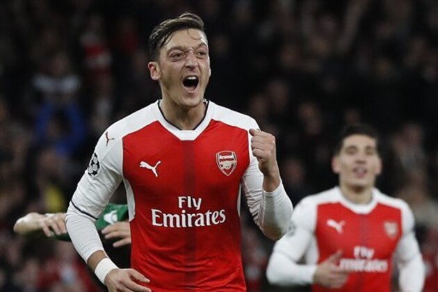 Arsenal's Mesut Ozil, left, celebrates after scoring his side's fifth goal  during the Champions League Group A soccer match between Arsenal and Ludogorets Razgrad at Emirates stadium in London Wednesday, Oct. 19, 2016. (AP Photo/Kirsty Wigglesworth)