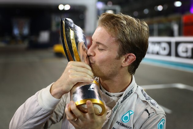 ABU DHABI, UNITED ARAB EMIRATES - NOVEMBER 27:  Nico Rosberg of Germany and Mercedes GP celebrates with his second place trophy after securing the F1 World Drivers Championship during the Abu Dhabi Formula One Grand Prix at Yas Marina Circuit on November 27, 2016 in Abu Dhabi, United Arab Emirates.  (Photo by Clive Mason/Getty Images)