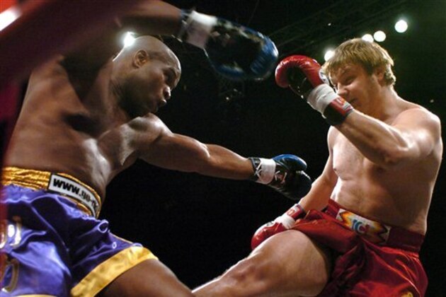 Gary Goodridge, left, of Trinidad and Tobago fights with Aleksei Ignashov of Belarus during their match in the preliminaries of the K-1 European League in Pap Laszlo Sports Arena in Budapest, Saturday night, Feb. 25, 2006. K-1 is a martial arts fighting sport which fuses karate, kung fu, tae kwon do and kickboxing (the