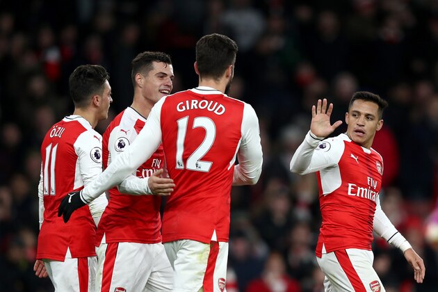 LONDON, ENGLAND - NOVEMBER 27: Alexis Sanchez of Arsenal (R) celebrates scoring his sides third goal with his Arsenal team mates during the Premier League match between Arsenal and AFC Bournemouth at Emirates Stadium on November 27, 2016 in London, England.  (Photo by Clive Rose/Getty Images)