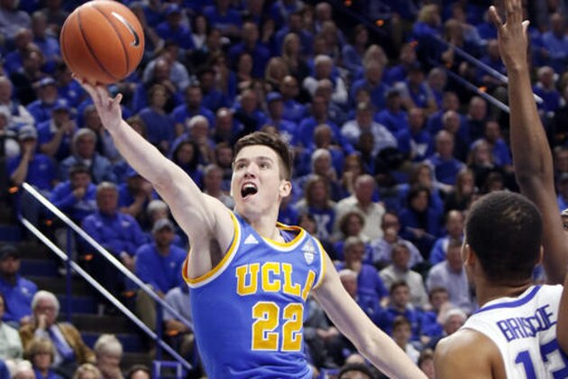 UCLA's TJ Leaf shoots near Kentucky's Isaiah Briscoe during the second half of an NCAA college basketball game, Saturday, Dec. 3, 2016, in Lexington, Ky. UCLA upset No. 1 Kentucky 97-92. (AP Photo/James Crisp)