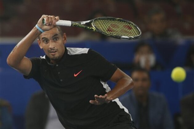 OUE Singapore Slammers player Nick Kyrgios, from Australia, returns a ball during the International Premier Tennis League (IPTL) a men’s doubles tennis match between OUE Singapore Slammers and Legendari Japan Warriors in New Delhi, India, Saturday, Dec. 12, 2015. (AP Photo/Tsering Topgyal)