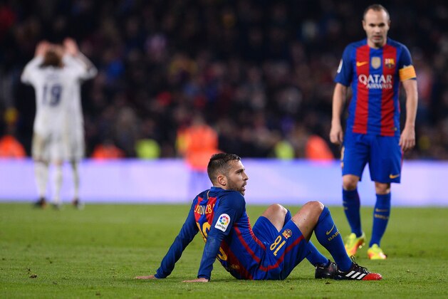 Barcelona's defender Jordi Alba sits on the pitch as he reacts following their 1-1 draw at the end of the Spanish league football match FC Barcelona vs Real Madrid CF at the Camp Nou stadium in Barcelona on December 3, 2016. / AFP / JOSEP LAGO        (Photo credit should read JOSEP LAGO/AFP/Getty Images)