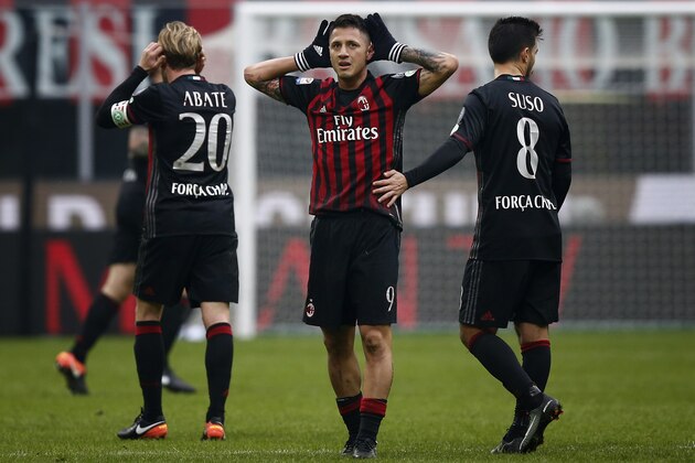 AC Milan's forward Giacomo Lapadula (C) celebrates after scoring during the Italian Serie A football match AC Milan Vs Crotone on December 4, 2016 at the 'San Siro Stadium' in Milan.  / AFP / MARCO BERTORELLO        (Photo credit should read MARCO BERTORELLO/AFP/Getty Images)