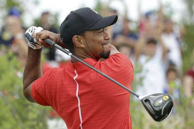 Tiger Woods watches his tee shot on the first hole during the final round at the Hero World Challenge golf tournament, Sunday, Dec. 4, 2016, in Nassau, Bahamas. (AP Photo/Lynne Sladky)