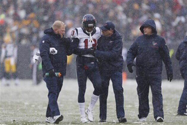Houston Texans' Braxton Miller is helped off the field during the first half of an NFL football game against the Green Bay Packers Sunday, Dec. 4, 2016, in Green Bay, Wis. (AP Photo/Matt Ludtke)