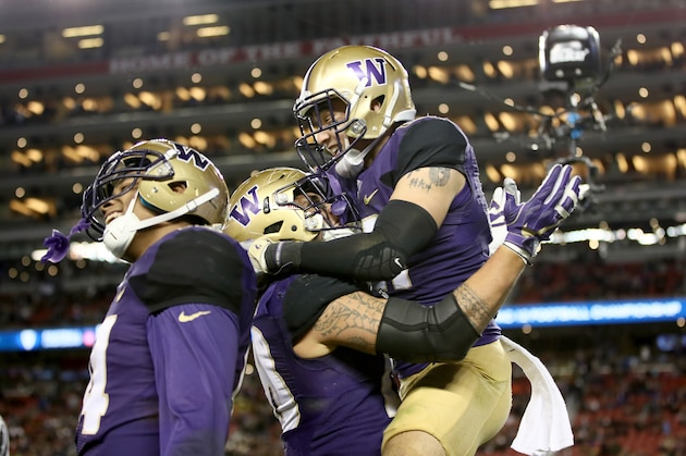 SANTA CLARA, CA - DECEMBER 02:  Taylor Rapp #21 of the Washington Huskies jumps in to the arms of Psalm Wooching #28 after making his interception against the Colorado Buffaloes in the Pac-12 Championship game at Levi's Stadium on December 2, 2016 in Santa Clara, California.  (Photo by Robert Reiners/Getty Images)