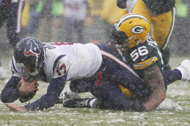 Houston Texans quarterback Brock Osweiler is sacked by Green Bay Packers' Julius Peppers during the first half of an NFL football game Sunday, Dec. 4, 2016, in Green Bay, Wis. (AP Photo/Mike Roemer)