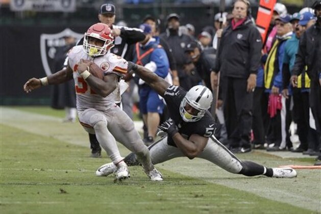 Kansas City Chiefs running back Spencer Ware (32) runs against Oakland Raiders outside linebacker Bruce Irvin during an NFL football game in Oakland, Calif., Sunday, Oct. 16, 2016. (AP Photo/Marcio Jose Sanchez)