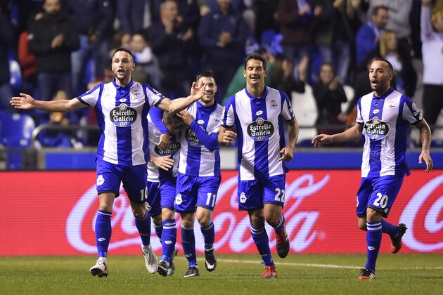 (L-R) Deportivo La Coruna's Romanian forward Florin Andone, midfielder Carles Gil, Costa Rican midfielder Celso Borges and Brazilian midfielder Guilherme Dos Santos celebrate after scoring their second goal during the Spanish league football match RC Deportivo de la Coruna vs Real Sociedad at the Municipal de Riazor stadium in La Coruna on December 5, 2016. / AFP / MIGUEL RIOPA        (Photo credit should read MIGUEL RIOPA/AFP/Getty Images)