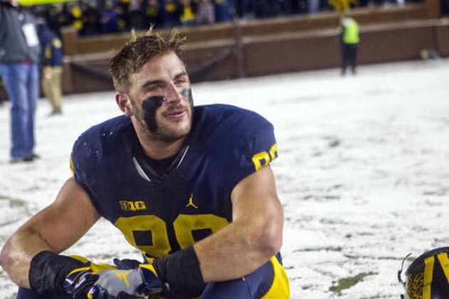 Michigan tight end Jake Butt (88) shows emotion as he stands on the Michigan Stadium field after an NCAA college football game against Indiana in Ann Arbor, Mich., Saturday, Nov. 19, 2016. Michigan won 20-10. (AP Photo/Tony Ding)