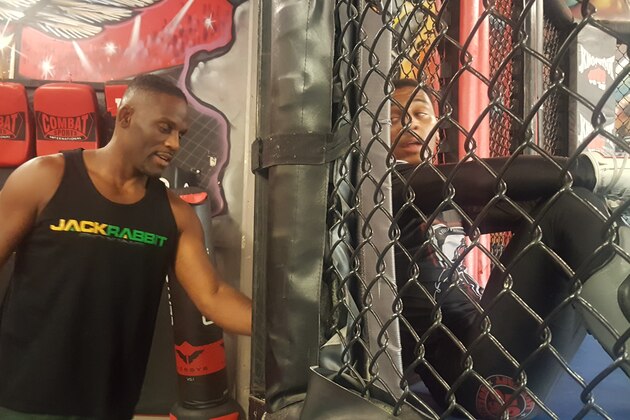 Antonio McKee (left) talks with his son A.J. McKee (right) during a training session.