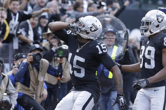 Oakland Raiders wide receiver Michael Crabtree (15) celebrates after scoring a touchdown with wide receiver Amari Cooper (89) during the second half of an NFL football game against the Buffalo Bills in Oakland, Calif., Sunday, Dec. 4, 2016. (AP Photo/Ben Margot)