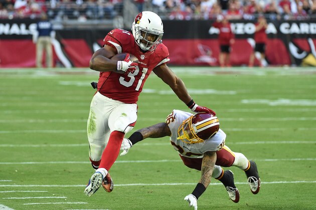 GLENDALE, AZ - DECEMBER 04:  David Johnson #31 of the Arizona Cardinals runs with the ball while straight arming Su'a Cravens #36 of the Washington Redskins during the third quarter at University of Phoenix Stadium on December 4, 2016 in Glendale, Arizona.  (Photo by Norm Hall/Getty Images)
