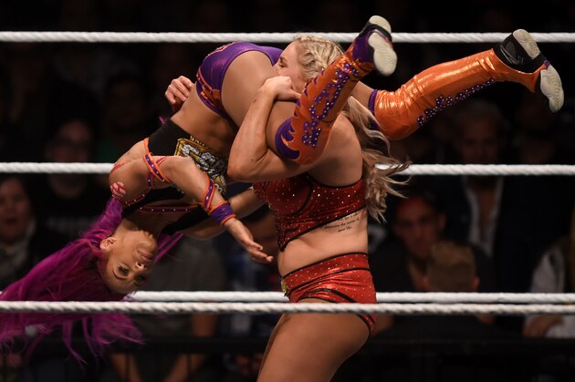 WWE wrestling stars Sasha Bank (L) and Charlotte Flair fight during a WWE (World Wrestling Entertainment) women's fight at the Olympic hall in Munich, southern Germany, on November 3, 2016.  / AFP / CHRISTOF STACHE        (Photo credit should read CHRISTOF STACHE/AFP/Getty Images)