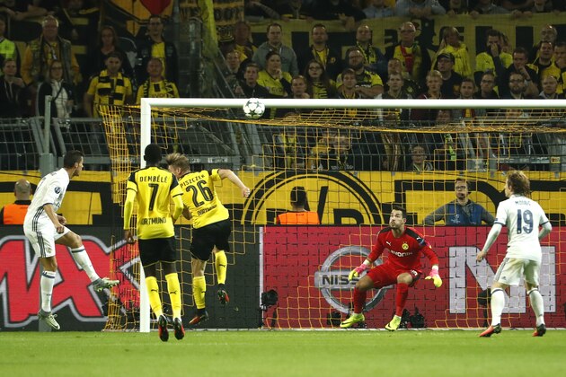 CORRECTION - Real Madrid's Portuguese forward Cristiano Ronaldo (L) reacts after scoring a goal that was disallowed past Dortmund's Swiss goalkeeper Roman Buerki during the UEFA Champions League first leg football match between Borussia Dortmund and Real Madrid at BVB stadium in Dortmund, on September 27, 2016. / AFP / Odd ANDERSEN / The erroneous mention[s] appearing in the metadata of this photo by Odd ANDERSEN has been modified in AFP systems in the following manner: [-Real Madrid's Portuguese forward Cristiano Ronaldo (L) raects after scoring a goal that was disallowed past Dortmund's Swiss goalkeeper Roman Buerki--] instead of [-Real Madrid's Portuguese forward Cristiano Ronaldo (L) raects after scoring a goal  past Dortmund's goalkeeper Roman Weidenfeller--]. Please immediately remove the erroneous mention[s] from all your online services and delete it (them) from your servers. If you have been authorized by AFP to distribute it (them) to third parties, please ensure that the same actions are carried ou